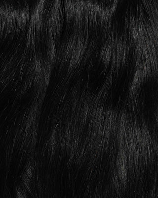 A close-up of long, wavy hair extensions showcasing their texture.