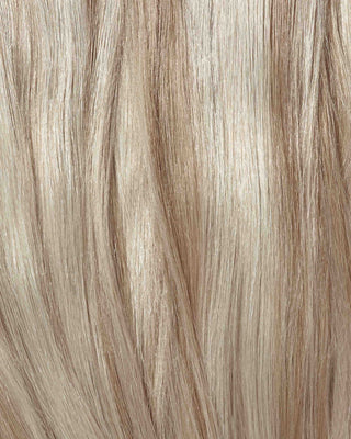 A close-up of a blonde wig featuring light blonde hair, showcasing the texture and shine of hair extensions.