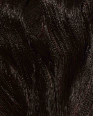 A close-up of long, dark brown hair extensions, showcasing their natural texture and shine.