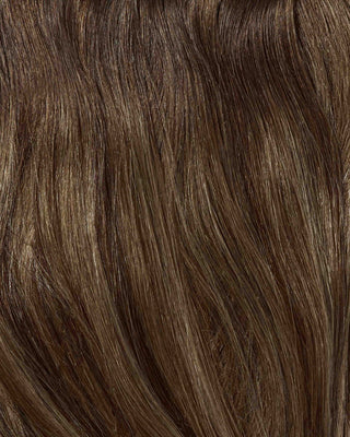 A close-up of a woman's hair featuring brown highlights and blonde balayage extensions, showcasing a vibrant and stylish look.