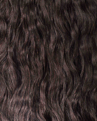 A detailed view of luxurious, long wavy hair extensions, highlighting their natural flow and shine.