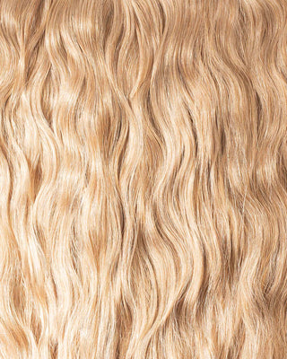 A clip-in hair extension featuring luxurious blonde strands for a seamless and stylish look.