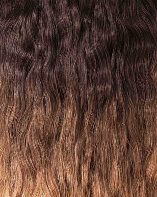 A close-up of long, wavy hair extensions showcasing their texture and shine.