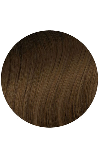 A close-up of a circle of honey-dipped color melt hair extensions on a white background.